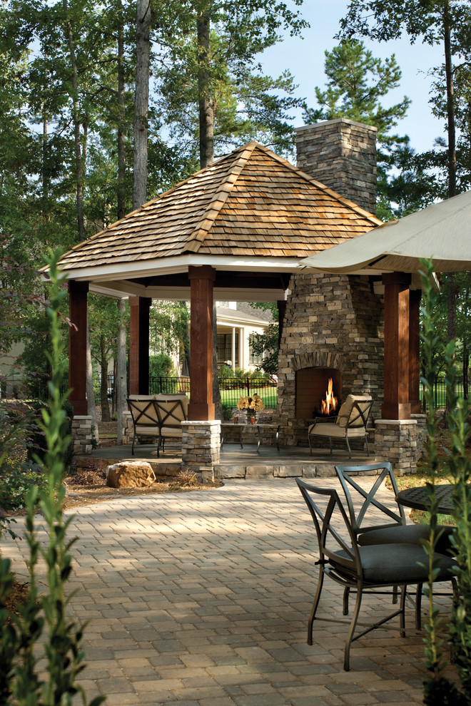 This is an example of a traditional patio in Tampa with a fire feature.