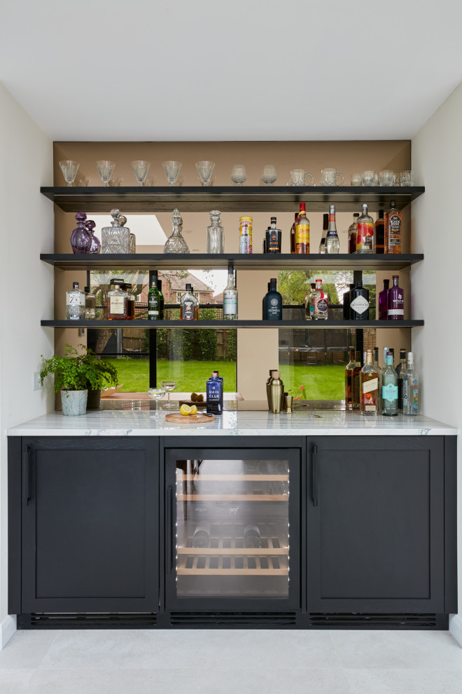 Design ideas for a large scandinavian home bar in London with a drop-in sink, flat-panel cabinets, black cabinets, quartzite benchtops, multi-coloured splashback and multi-coloured benchtop.
