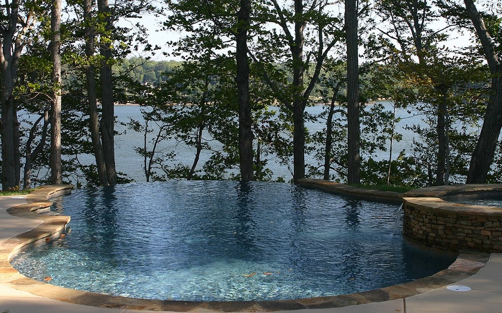 Inspiration for a mid-sized transitional backyard concrete paver and custom-shaped infinity hot tub remodel in Charlotte