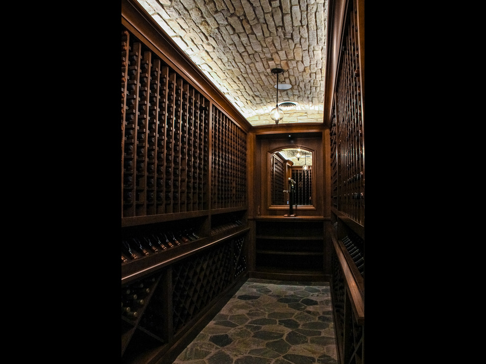 Photo of a large beach style wine cellar in Other with slate floors, grey floor and diamond bins.