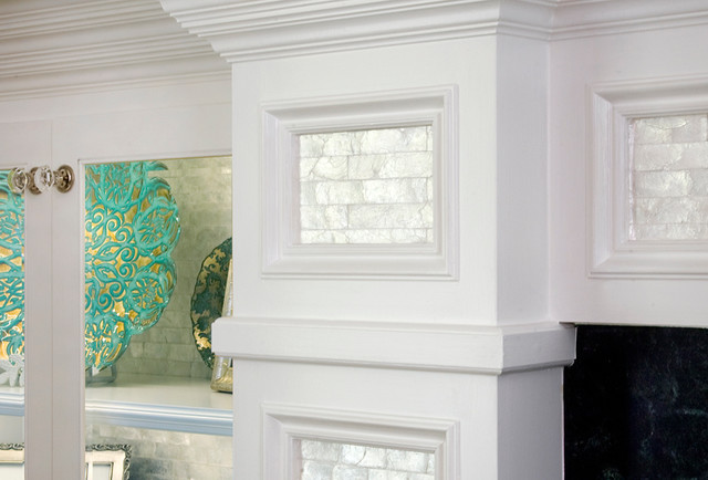 Real mother of pearl adorns the recessed panels of this custom fire place surround.  To add to the sense of depth and interest in the room