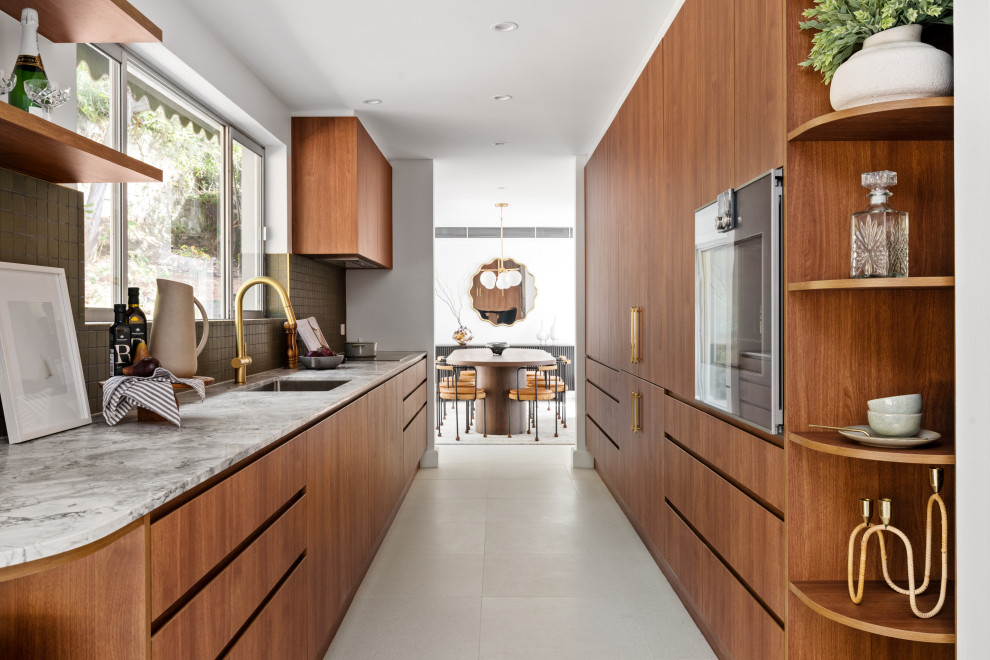 Photo of a large contemporary galley separate kitchen in Sydney with an undermount sink, flat-panel cabinets, medium wood cabinets, marble benchtops, stainless steel appliances, ceramic floors, no island, grey floor, grey splashback, mosaic tile splashback and grey benchtop.