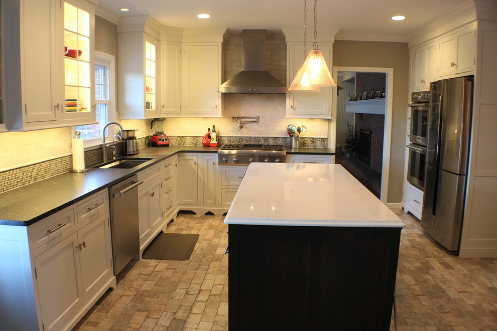 Inspiration for a large contemporary l-shaped porcelain tile eat-in kitchen remodel with an undermount sink, recessed-panel cabinets, white cabinets, granite countertops, beige backsplash, porcelain backsplash, stainless steel appliances and an island