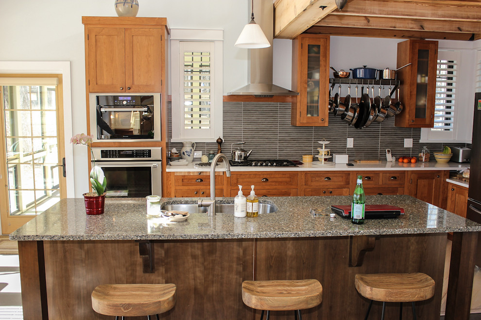Photo of a mid-sized eclectic l-shaped eat-in kitchen in Miami with granite benchtops and with island.