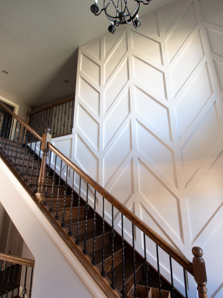 Design ideas for a staircase in Chicago with decorative wall panelling.