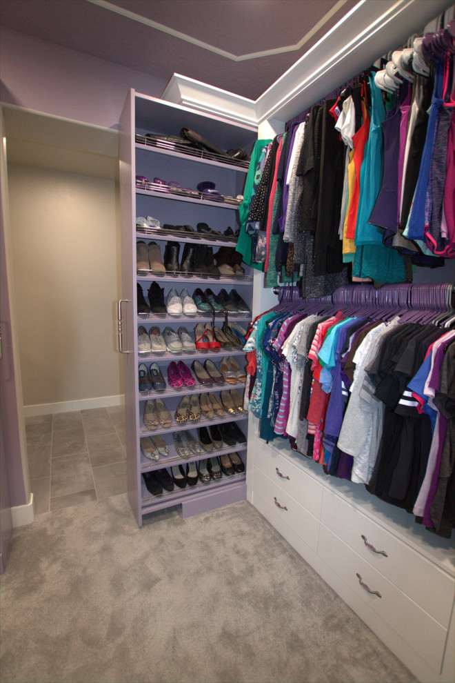 Design ideas for a large modern women's walk-in wardrobe in Salt Lake City with flat-panel cabinets, white cabinets, carpet, purple floor and coffered.