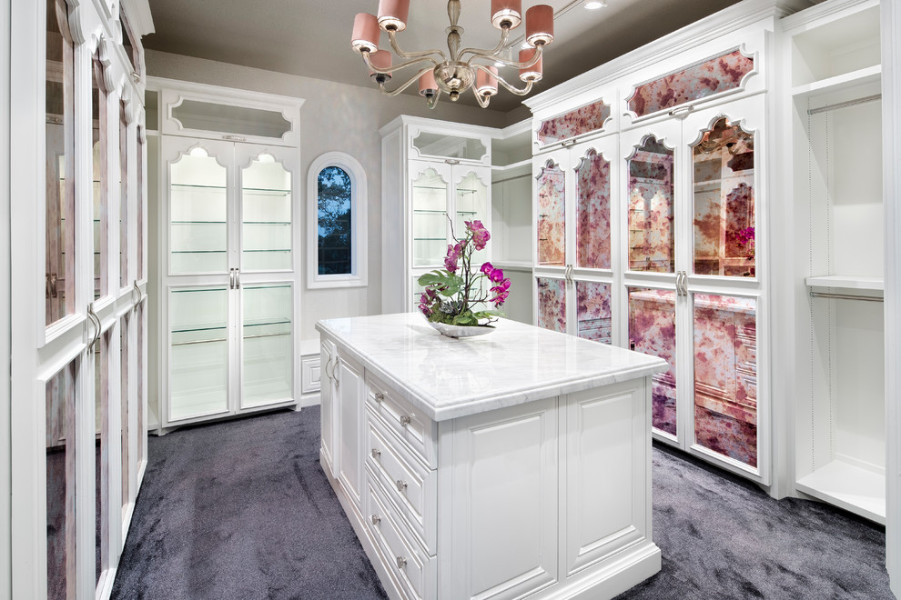 Design ideas for a mid-sized mediterranean women's dressing room in Austin with glass-front cabinets, white cabinets, carpet and purple floor.