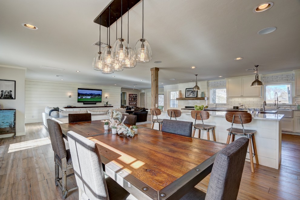 Design ideas for a mid-sized transitional open plan dining in Oklahoma City with white walls and medium hardwood floors.