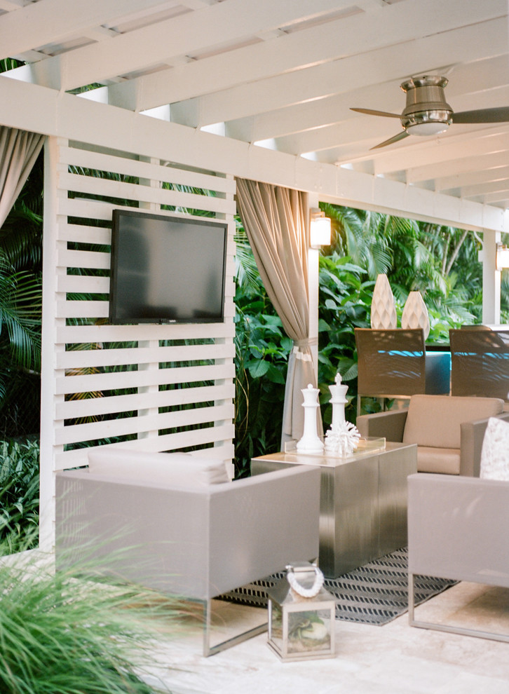 Mid-sized contemporary backyard patio in Miami with an outdoor kitchen, natural stone pavers and a pergola.