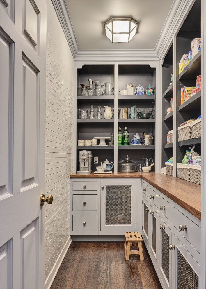 Design ideas for a traditional l-shaped kitchen pantry in New York with recessed-panel cabinets, grey cabinets, wood benchtops, dark hardwood floors, no island, brown floor and brown benchtop.