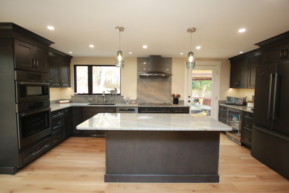 Eat-in kitchen - mid-sized transitional u-shaped laminate floor and brown floor eat-in kitchen idea in Boston with an undermount sink, shaker cabinets, brown cabinets, quartz countertops, black appliances, an island and multicolored countertops