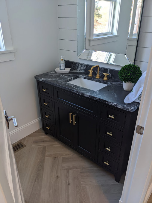 Inspiration for a small transitional kids bathroom in Providence with beaded inset cabinets, grey cabinets, white walls, porcelain floors, an undermount sink, granite benchtops, grey floor and black benchtops.