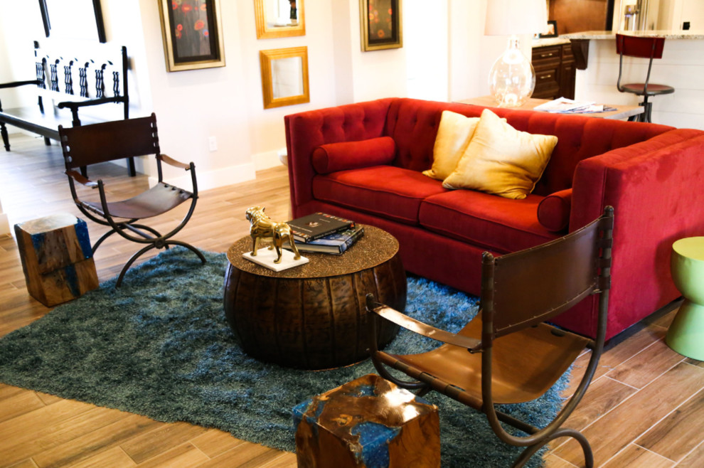 Example of a mid-sized transitional open concept light wood floor family room design with beige walls and a wall-mounted tv