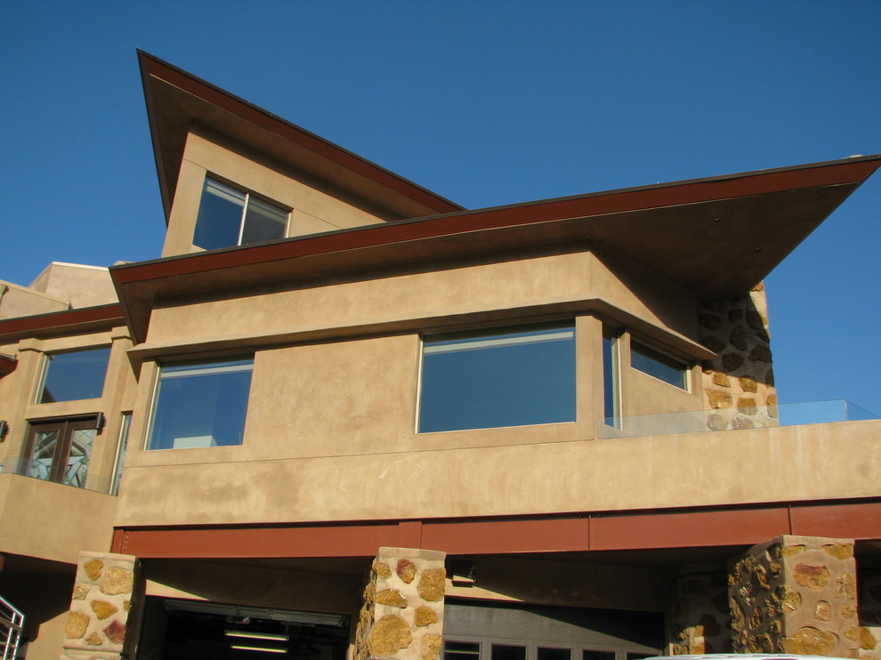 Photo of a large modern three-storey stucco beige exterior in San Francisco with a hip roof.