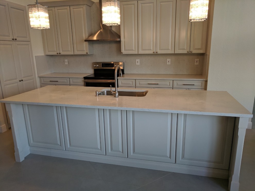 Eat-in kitchen - mid-sized transitional u-shaped porcelain tile and gray floor eat-in kitchen idea in Miami with an undermount sink, shaker cabinets, beige cabinets, quartz countertops, white backsplash, stone slab backsplash, stainless steel appliances, an island and white countertops