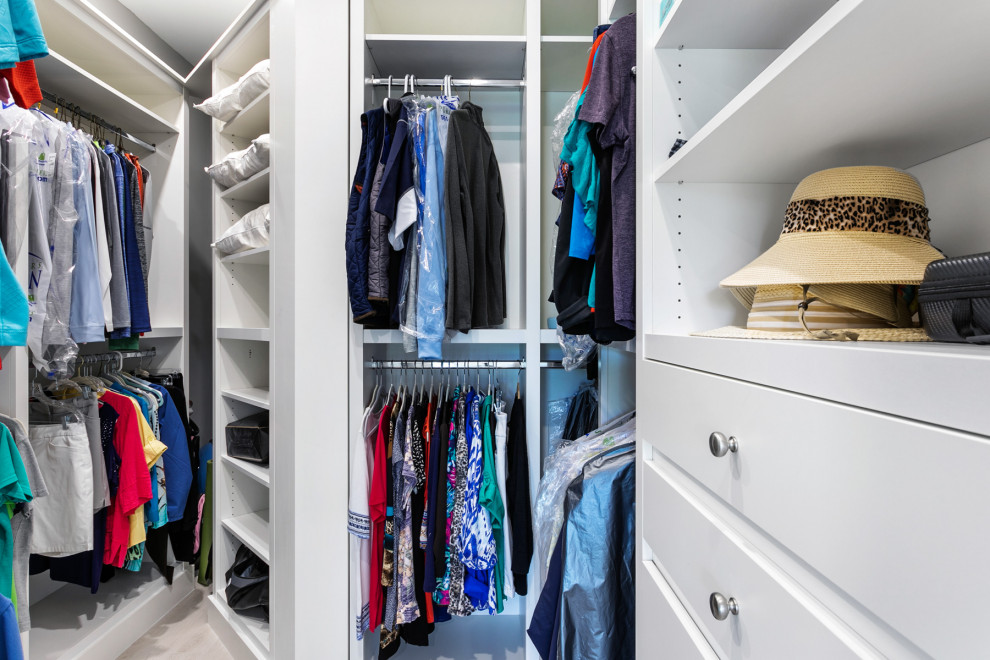 Large transitional gender-neutral storage and wardrobe in Miami with flat-panel cabinets, white cabinets, porcelain floors, grey floor and recessed.