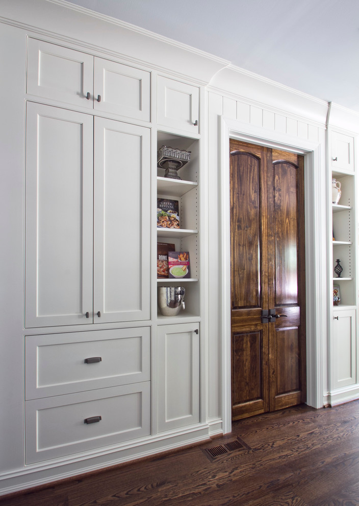 Large traditional kitchen in Atlanta with shaker cabinets, white cabinets, dark hardwood flooring and brown floors.