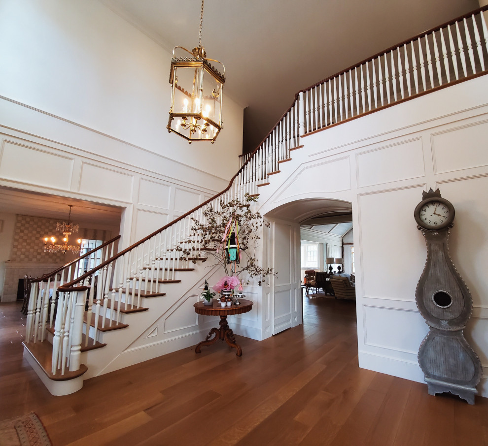 Photo of a large traditional wood l-shaped staircase in Salt Lake City with wood risers and wood railing.