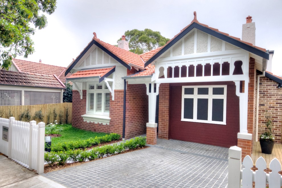 Design ideas for a large traditional two-storey brick red exterior in Sydney with a hip roof.