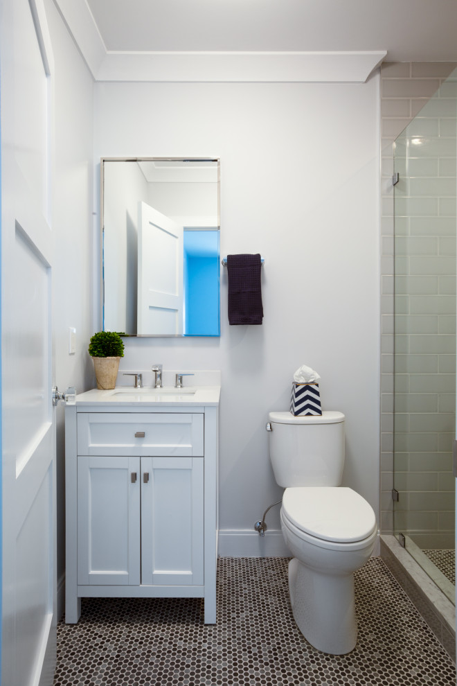 Inspiration for a mid-sized transitional 3/4 gray tile and porcelain tile porcelain tile, gray floor and single-sink alcove shower remodel in Boston with furniture-like cabinets, white cabinets, a two-piece toilet, blue walls, an undermount sink, quartz countertops, a hinged shower door, white countertops, a niche and a freestanding vanity