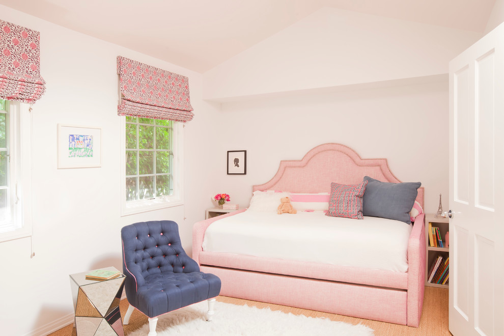This is an example of a mid-sized beach style kids' bedroom for girls in Los Angeles with white walls and carpet.