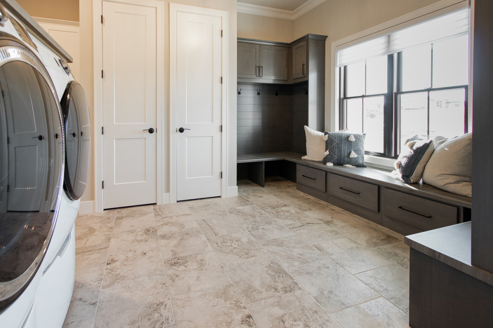 Example of a transitional porcelain tile and beige floor mudroom design in Other with beige walls