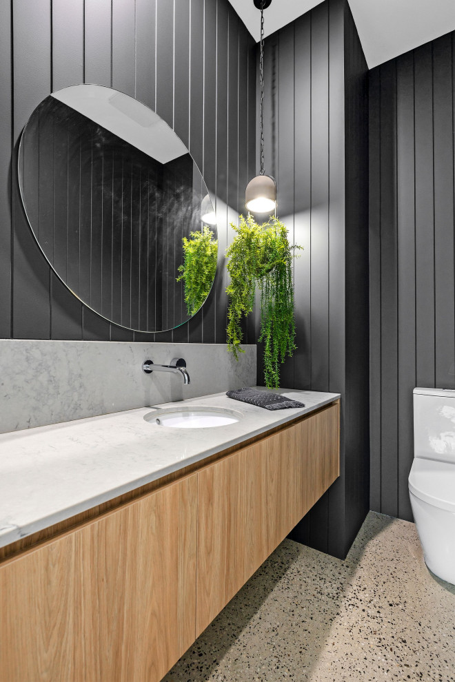 Inspiration for a large contemporary powder room in Geelong with flat-panel cabinets, grey walls, concrete floors, an undermount sink, engineered quartz benchtops, grey benchtops, a floating vanity and decorative wall panelling.