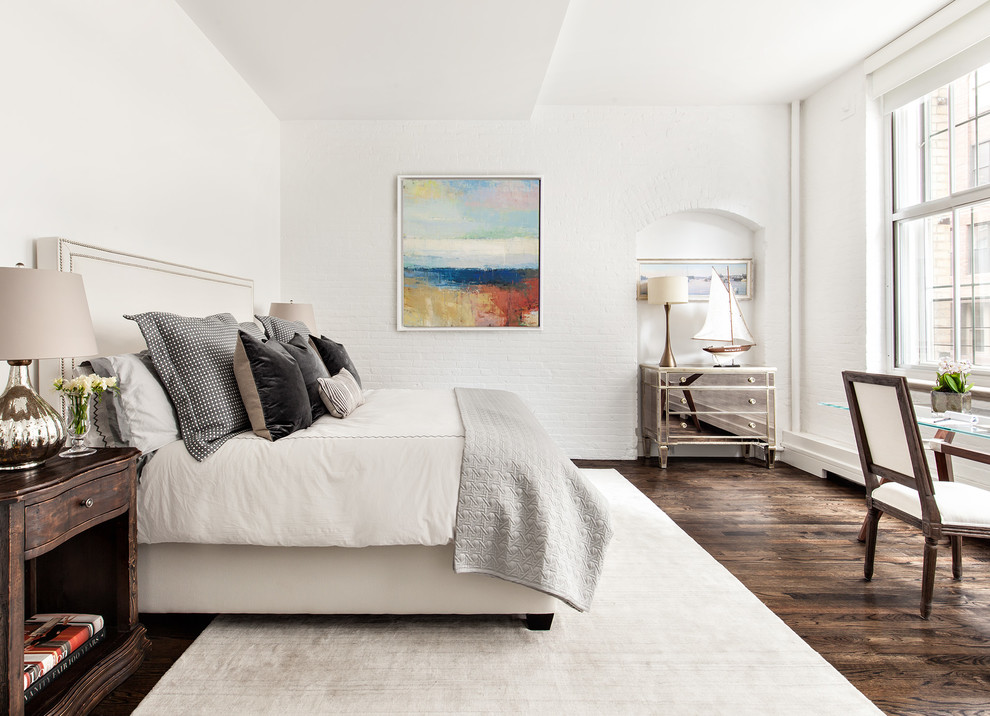 Transitional master bedroom in New York with white walls and dark hardwood floors.