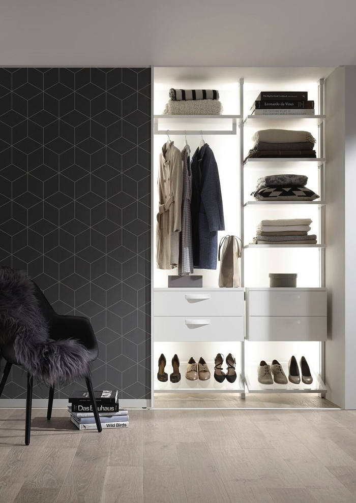 Inspiration for a small contemporary women's dressing room in Munich with open cabinets, white cabinets, light hardwood floors and beige floor.