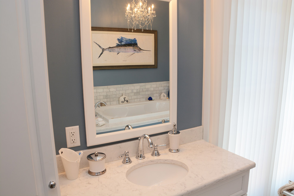 Design ideas for a large traditional master bathroom in Baltimore with raised-panel cabinets, white cabinets, an alcove tub, a corner shower, a two-piece toilet, white tile, blue walls, an undermount sink, engineered quartz benchtops, white floor, a hinged shower door and white benchtops.