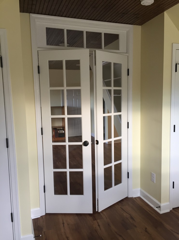 Example of a large classic loft-style vinyl floor home design design with yellow walls