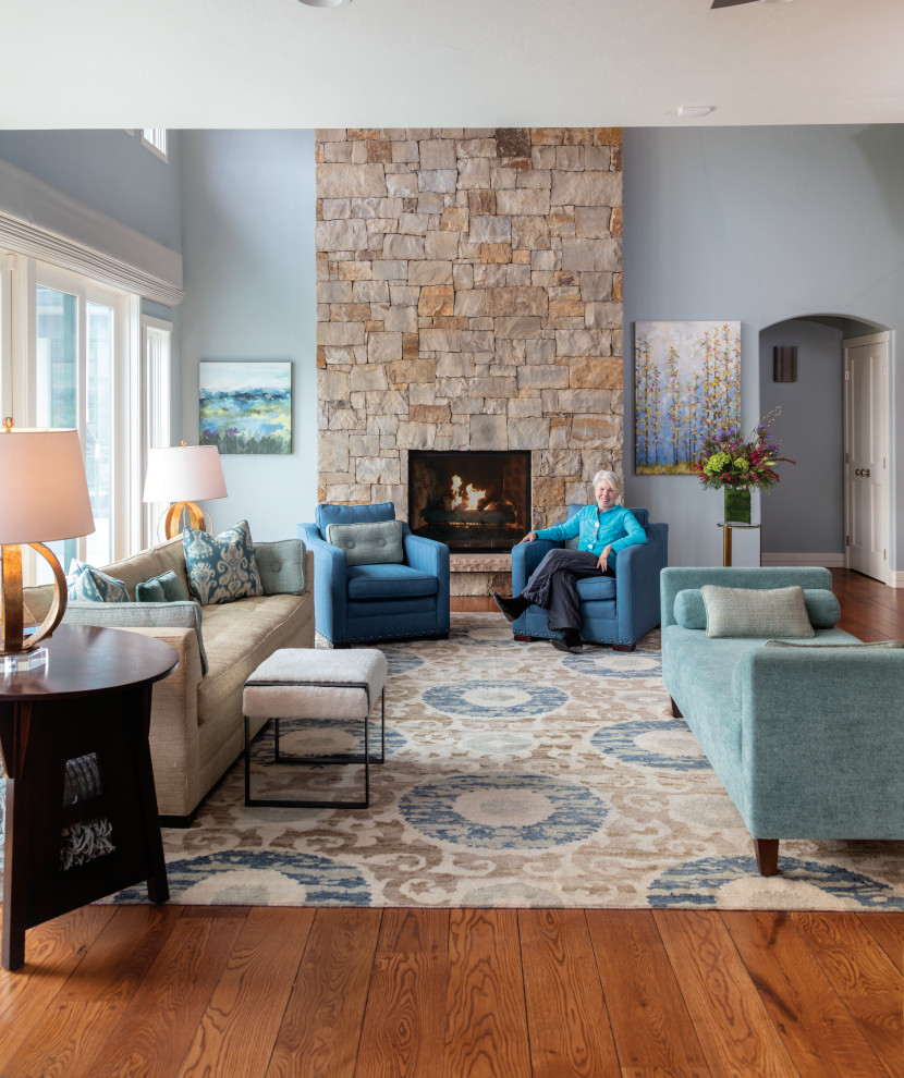 Mid-sized contemporary open concept living room in Denver with blue walls, medium hardwood floors, a two-sided fireplace, a stone fireplace surround, a built-in media wall, blue floor and exposed beam.