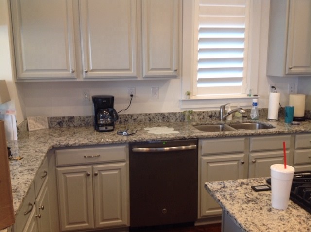 Inspiration for a mid-sized transitional u-shaped dark wood floor and brown floor kitchen pantry remodel with an undermount sink, raised-panel cabinets, gray cabinets, granite countertops, white backsplash, marble backsplash, stainless steel appliances, an island and gray countertops