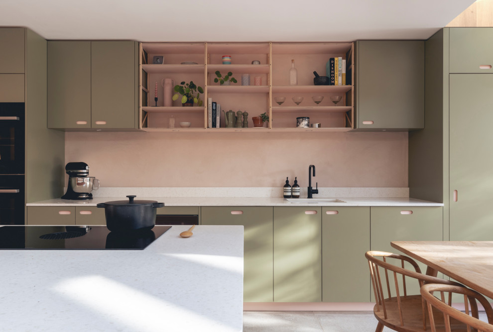 Photo of a scandinavian eat-in kitchen in London with an undermount sink, flat-panel cabinets, green cabinets, pink splashback and white benchtop.