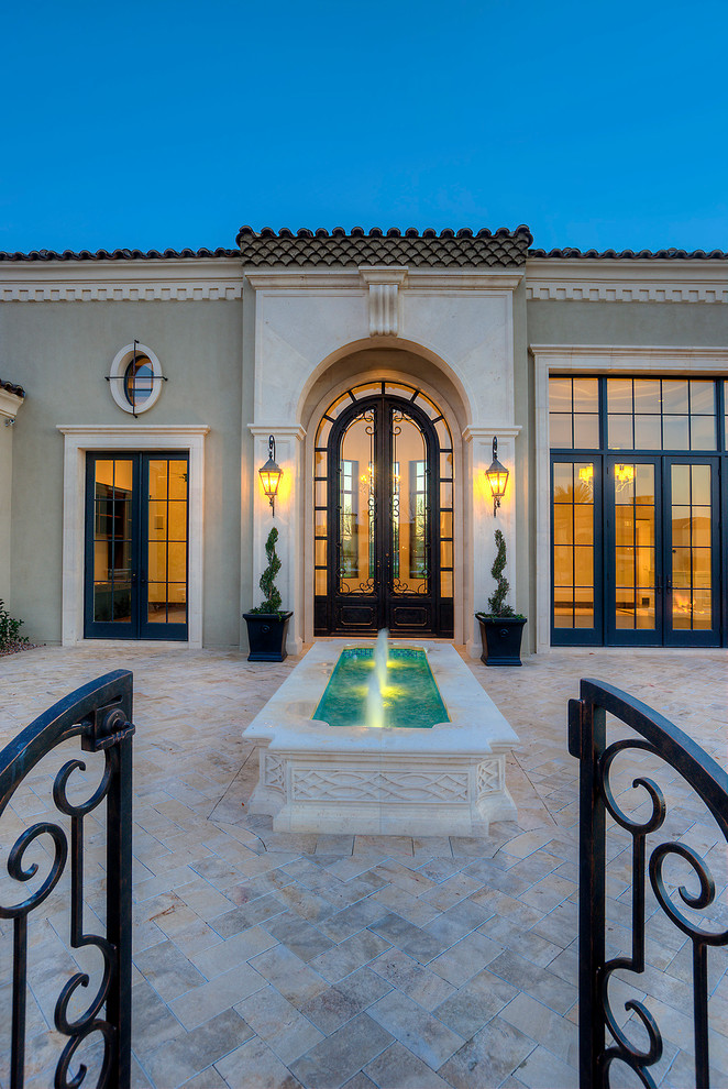 Huge elegant medium tone wood floor front door photo in Phoenix with beige walls and a glass front door