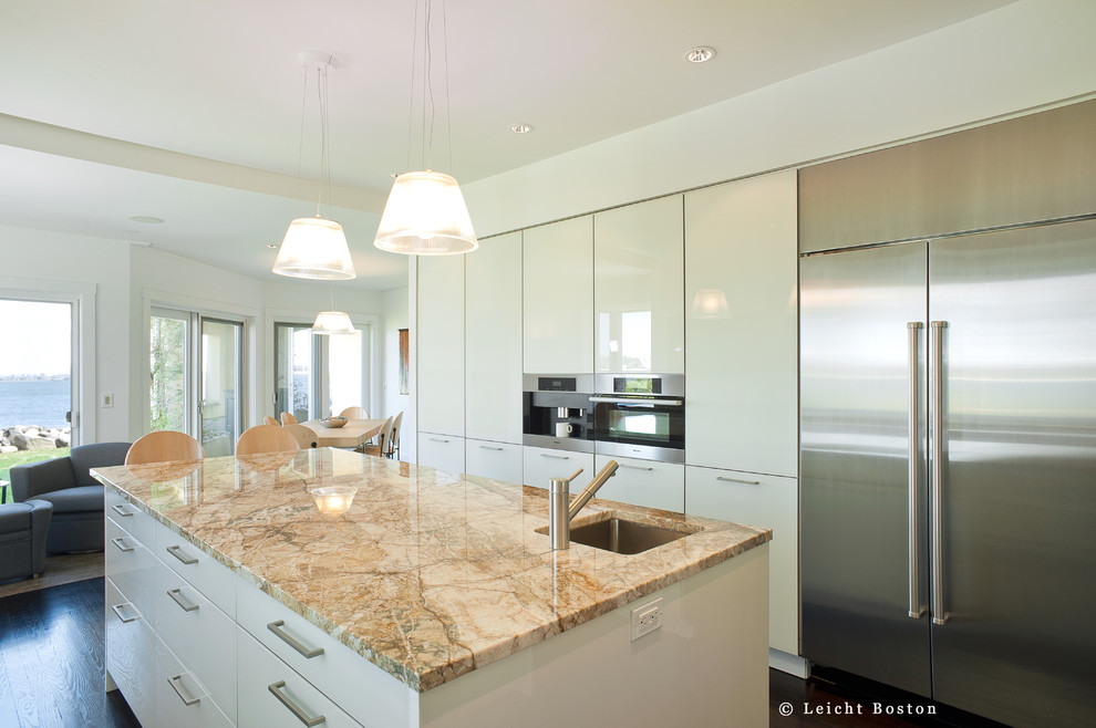 Photo of a large modern u-shaped eat-in kitchen in Boston with an undermount sink, flat-panel cabinets, white cabinets, granite benchtops, stainless steel appliances, dark hardwood floors and with island.