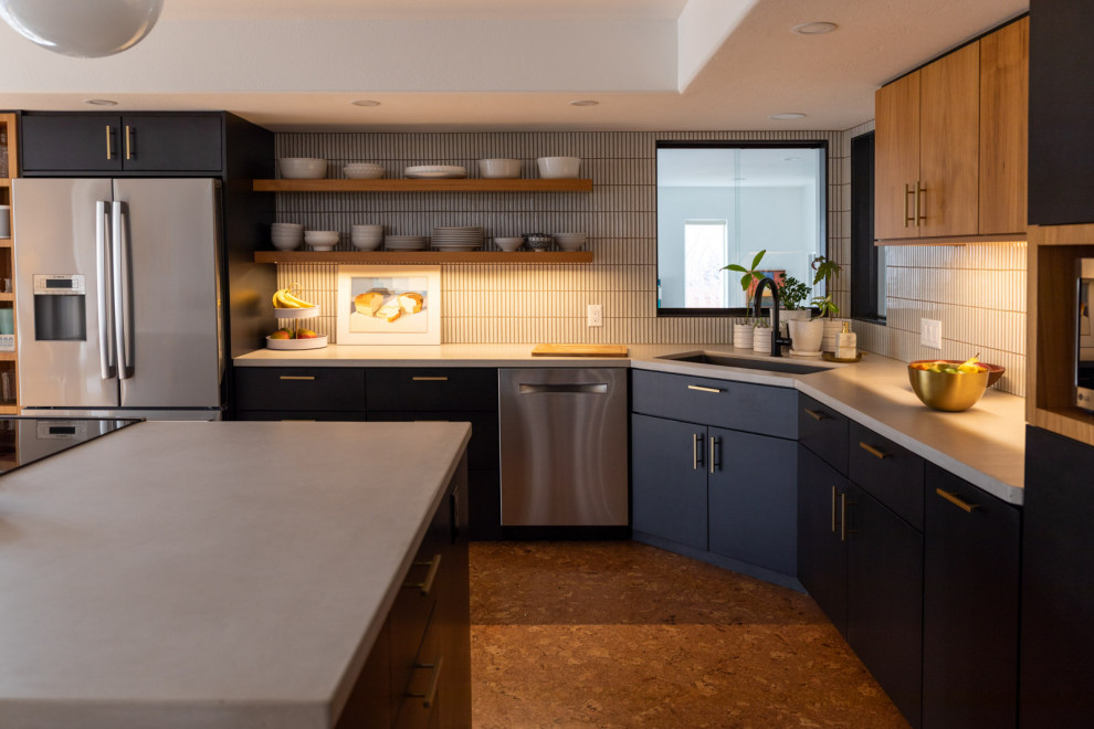 Photo of a mid-sized contemporary eat-in kitchen in Denver with a drop-in sink, flat-panel cabinets, blue cabinets, concrete benchtops, white splashback, subway tile splashback, stainless steel appliances, cork floors, with island, brown floor and white benchtop.