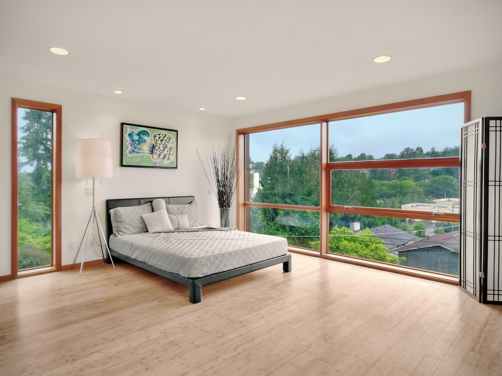 Design ideas for a modern bedroom in Seattle with bamboo floors.