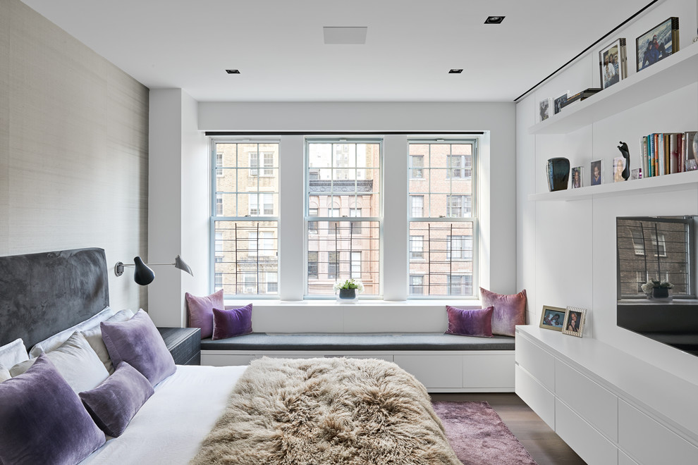 Design ideas for a mid-sized contemporary bedroom in New York with white walls, dark hardwood floors and brown floor.