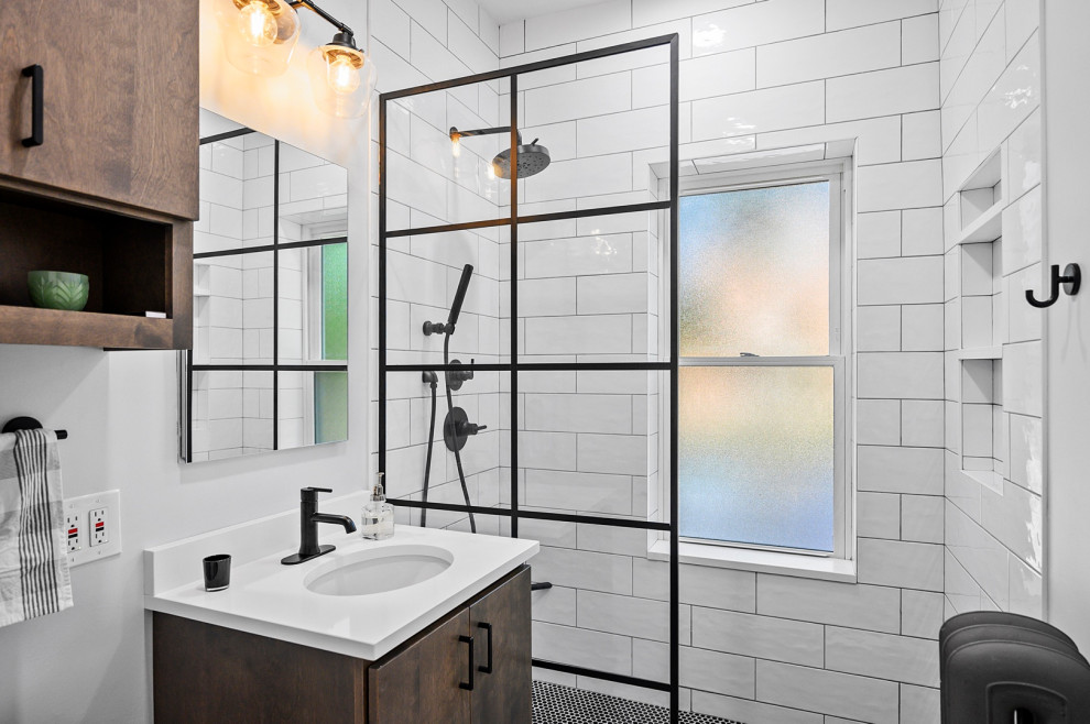Идея дизайна: главная ванная комната среднего размера в современном стиле с коричневыми фасадами, унитазом-моноблоком, черно-белой плиткой, цементной плиткой, белыми стенами, полом из керамической плитки, врезной раковиной, столешницей из искусственного кварца, разноцветным полом, нишей, тумбой под одну раковину, напольной тумбой, плоскими фасадами, душем в нише, душем с распашными дверями и белой столешницей