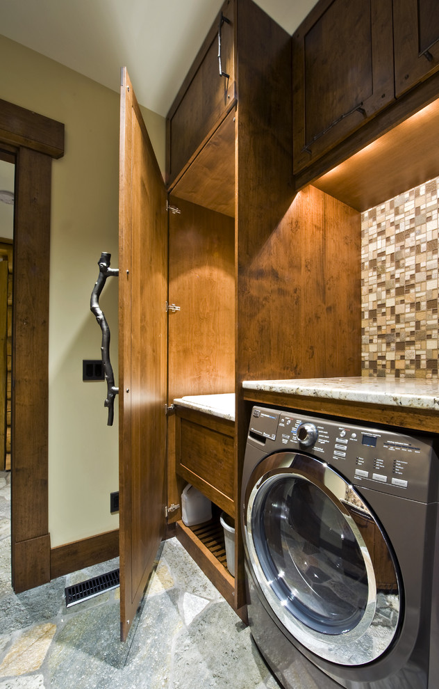 Photo of a country laundry room in Vancouver with dark wood cabinets.