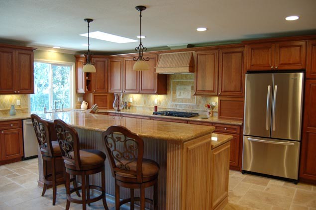 Inspiration for a large kitchen remodel in Minneapolis with an undermount sink, medium tone wood cabinets, multicolored backsplash, stainless steel appliances and an island
