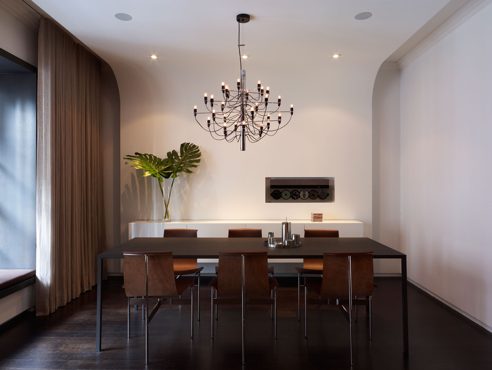 Inspiration for a modern dining room in New York with white walls and dark hardwood floors.