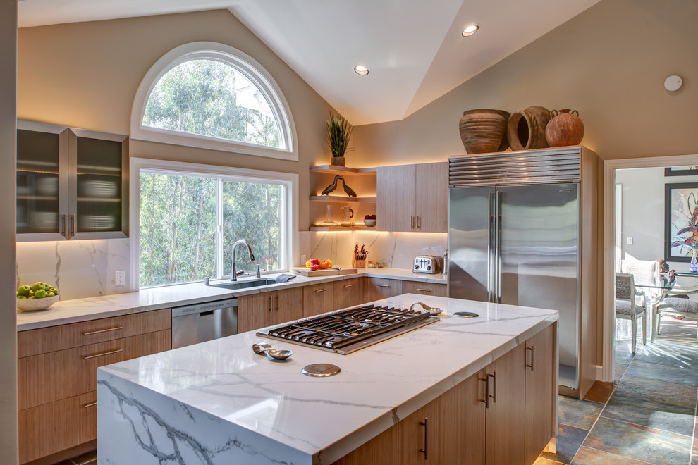 This is an example of a mid-sized transitional l-shaped separate kitchen in San Francisco with flat-panel cabinets, quartz benchtops, stainless steel appliances, porcelain floors, with island, an undermount sink, light wood cabinets, multi-coloured splashback and slate splashback.