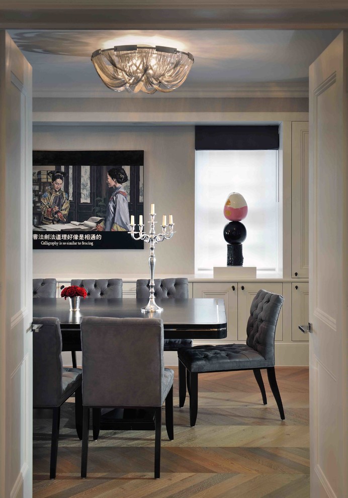 This is an example of a contemporary separate dining room in London with grey walls and medium hardwood floors.