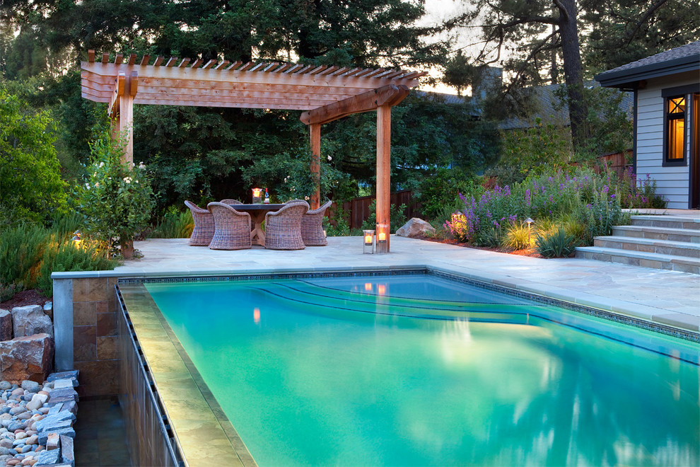 Inspiration for a contemporary infinity pool in Other with natural stone pavers.