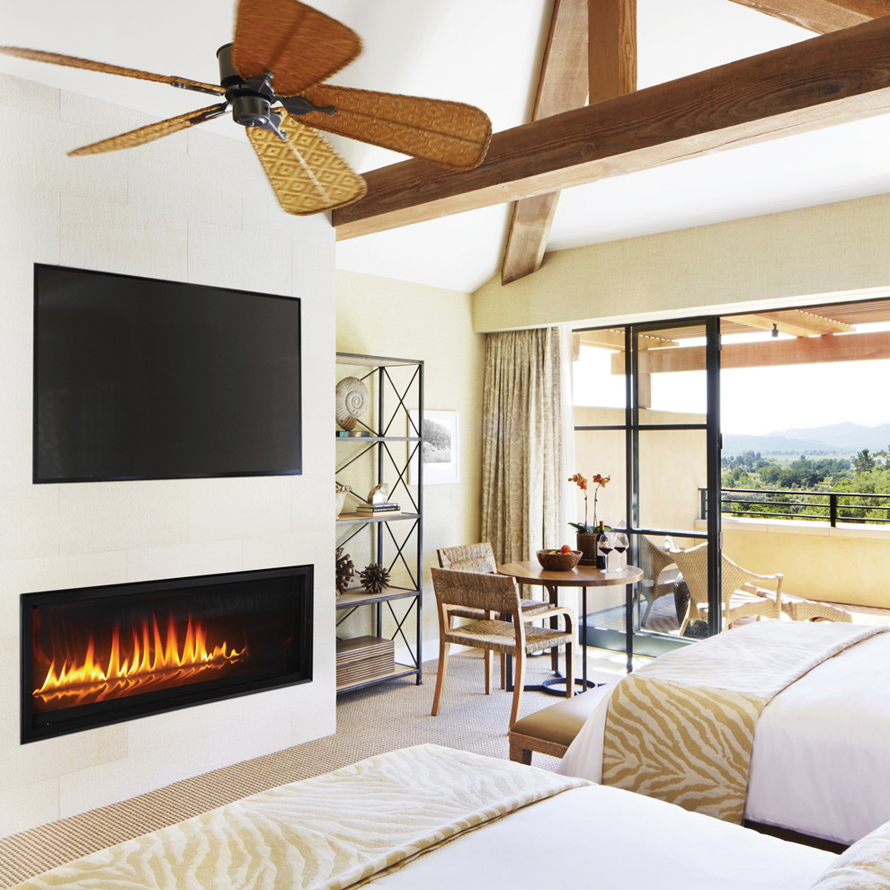 Contemporary bedroom in Orange County with a ribbon fireplace.