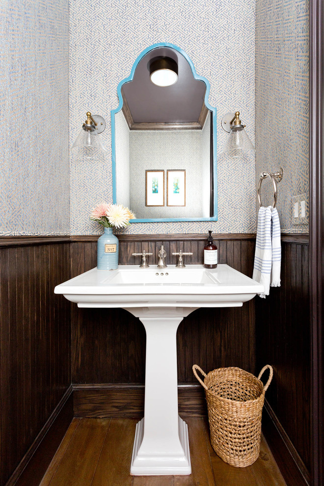 Design ideas for a beach style powder room in Los Angeles with medium hardwood floors, a pedestal sink and brown floor.