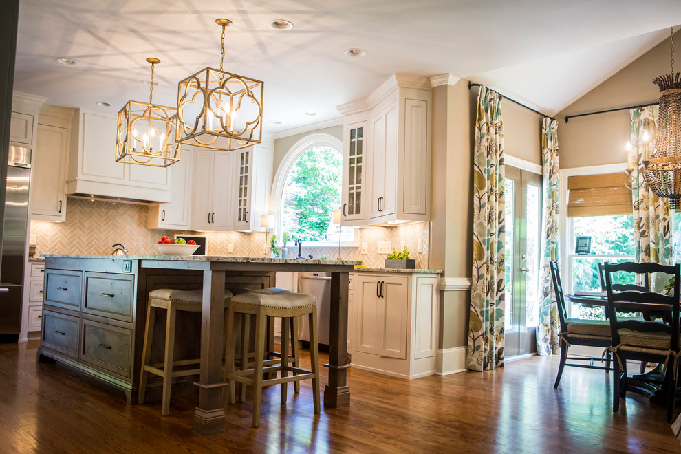 Large transitional l-shaped medium tone wood floor eat-in kitchen photo in Atlanta with a farmhouse sink, recessed-panel cabinets, white cabinets, granite countertops, gray backsplash, glass tile backsplash, stainless steel appliances and an island