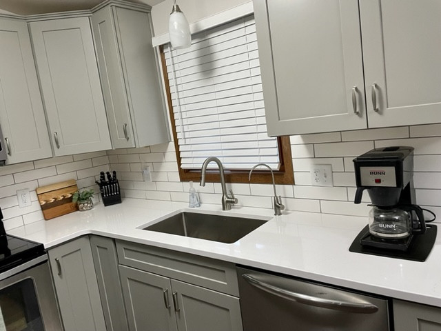 Small transitional u-shaped enclosed kitchen photo with shaker cabinets, gray cabinets and quartz countertops
